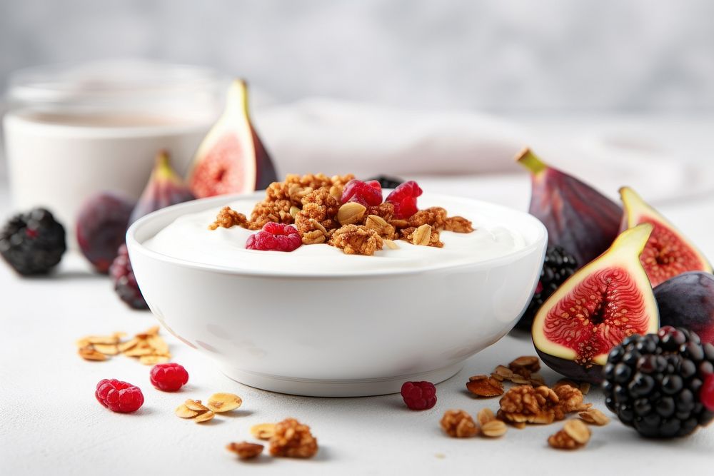 A bowl filled with Greek yogurt with figs sliced food produce fruit.