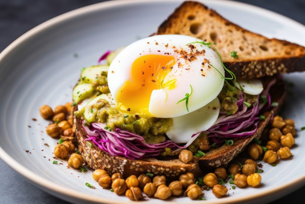 A bowl with spiced chickpeas and egg on top bread plate food.