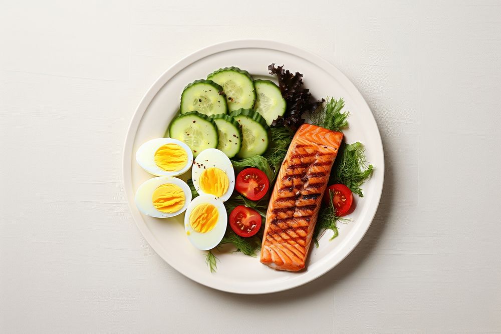 Avocado sliced and boiled eggs salmon plate food.