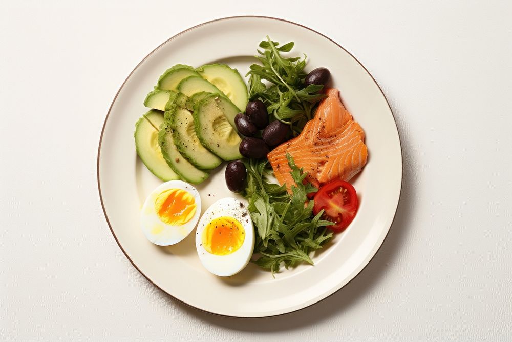 Avocado sliced and boiled eggs brunch plate food.