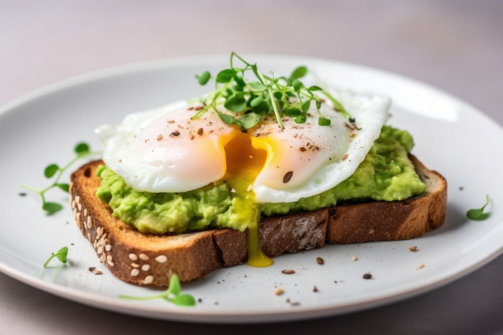 Mashed avocado toast with egg plate food bread.