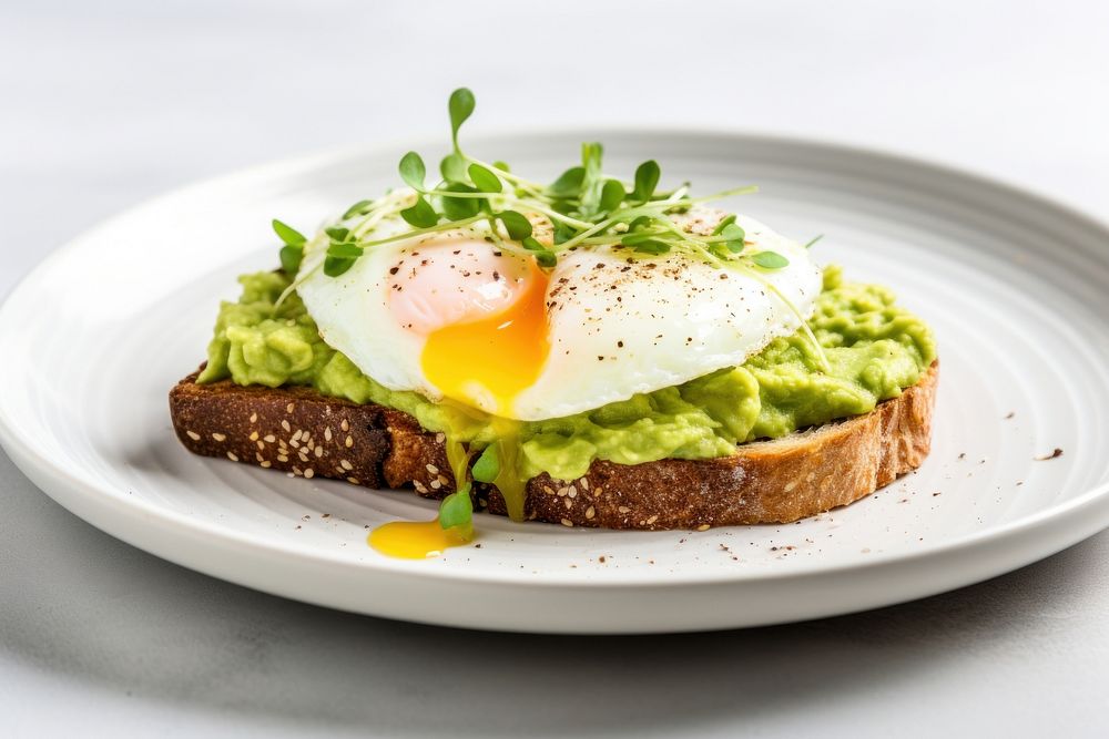 Mashed avocado toast with egg plate food.