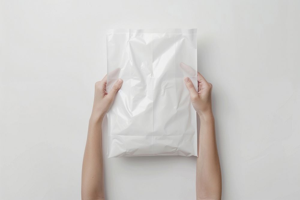 A white plastic mailing bag mockup cushion person pillow.