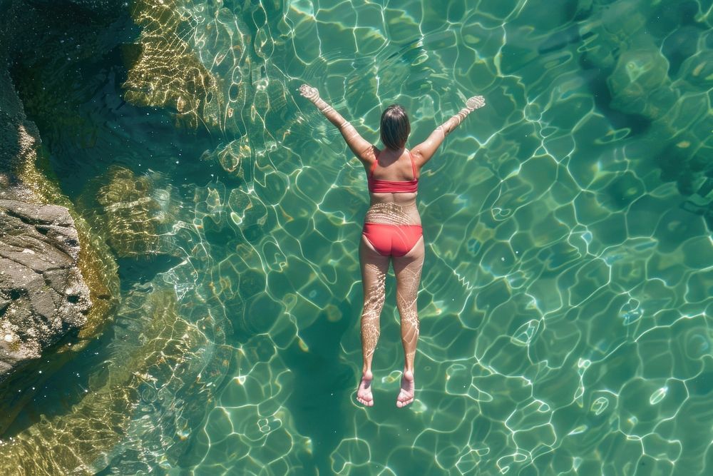 Brick color swimming suit floating on top of clear water summer photo photography.