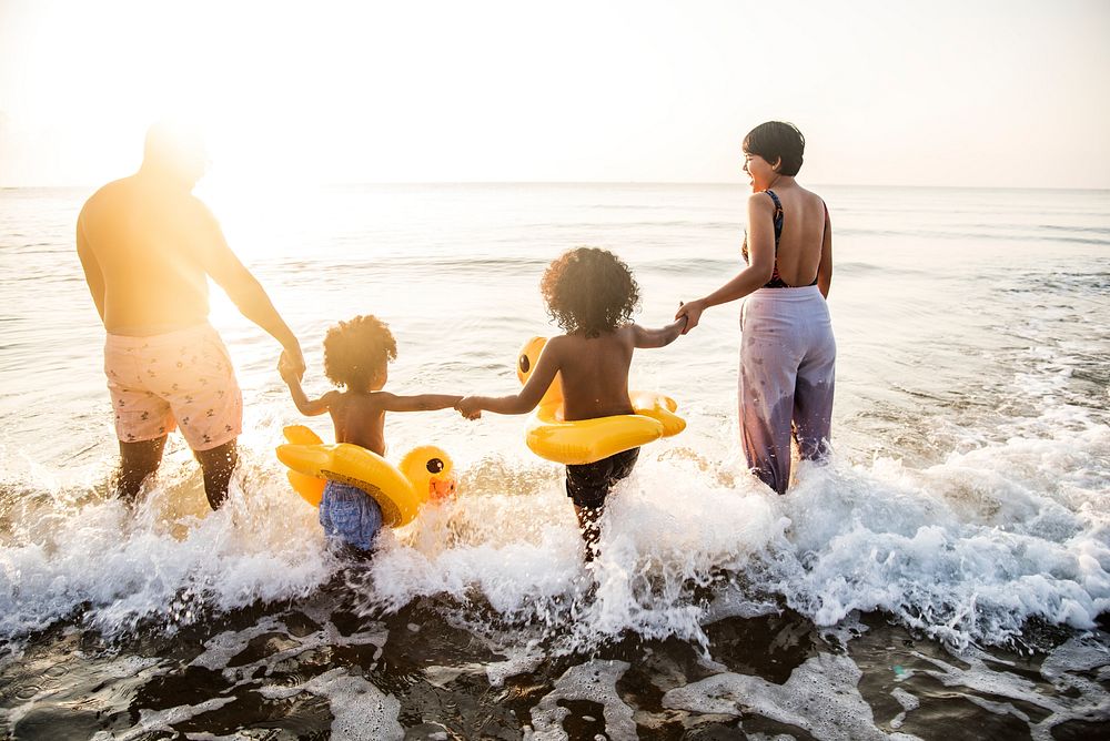 Black family enjoy the beach