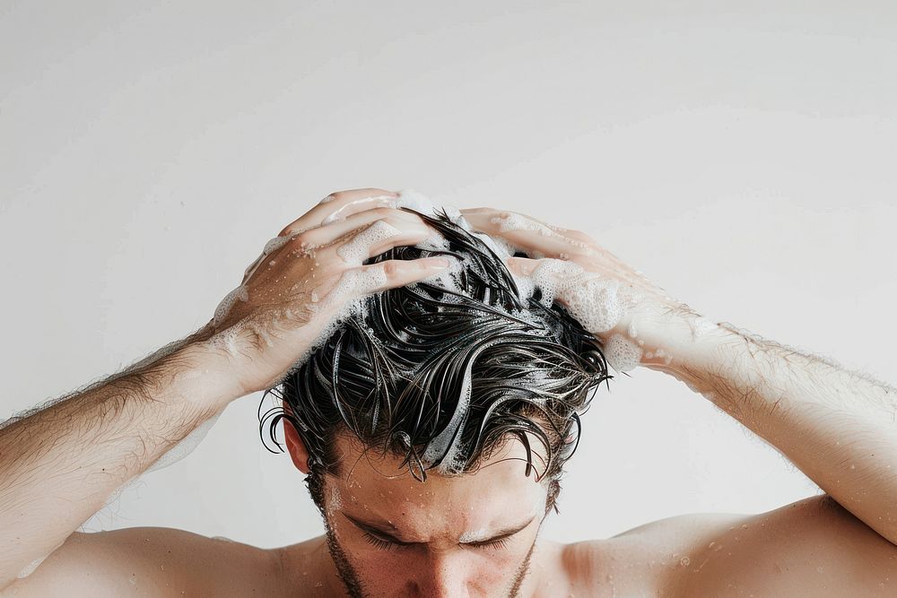 Man washing hair with shampoo