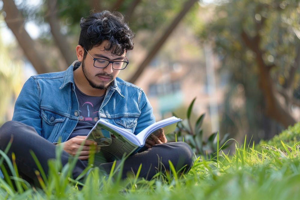 Man reading book outdoors