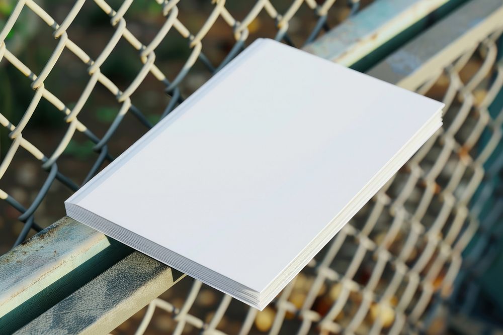 Blank book on metal fence