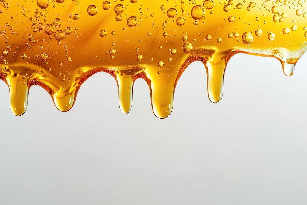 Golden honey dripping with bubbles