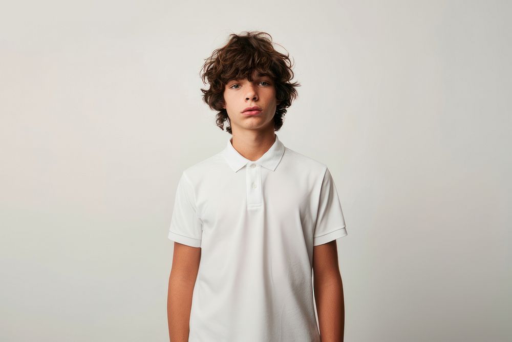 Teen boy wearing white polo