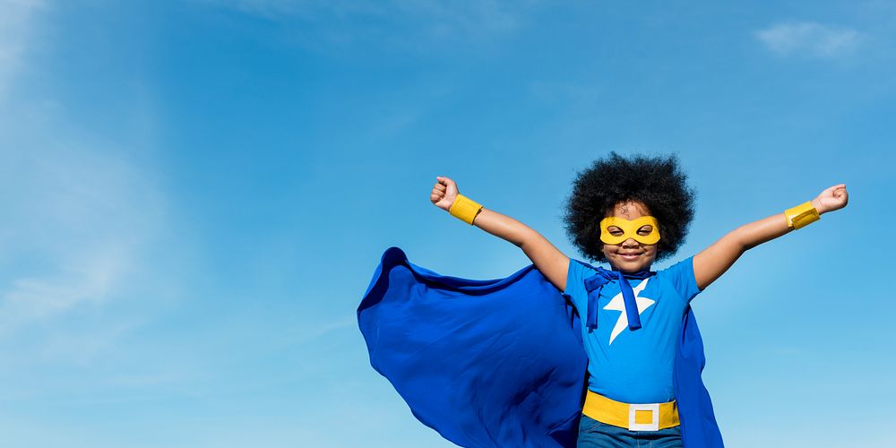 Child superhero costume blue sky