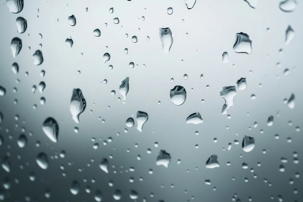 Raindrops dripping on glass photography background droplets.