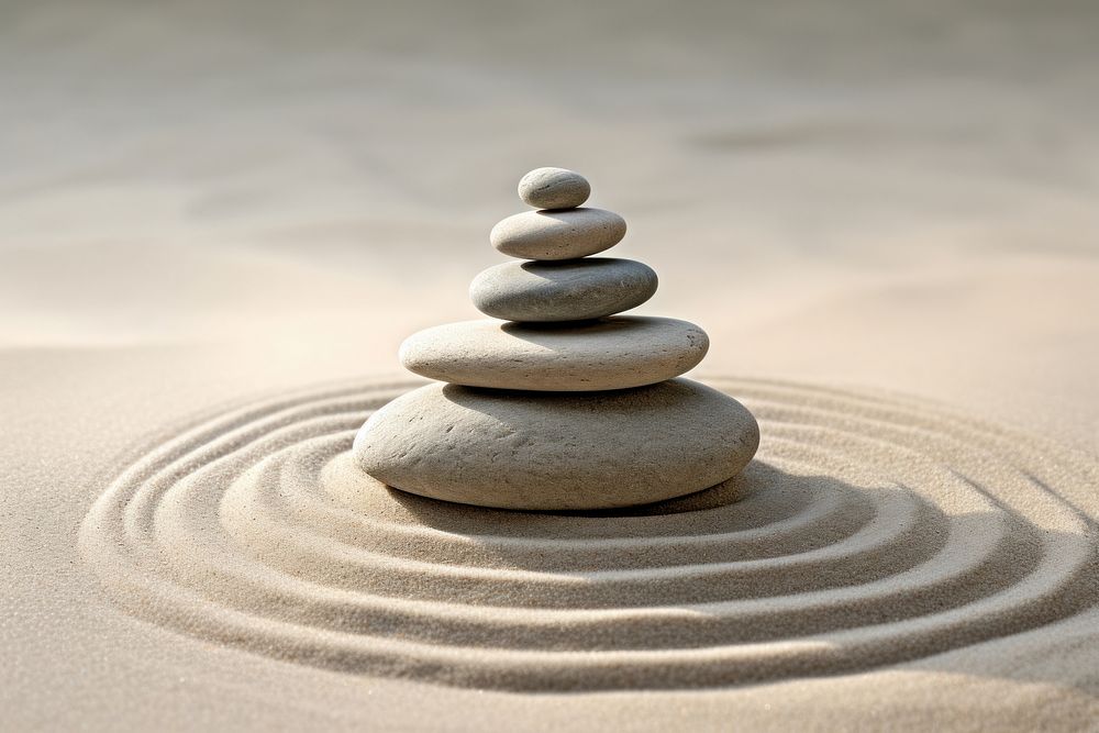 Balanced stones on sandy surface