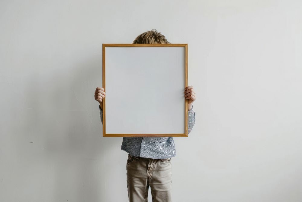 Child holding blank picture frame