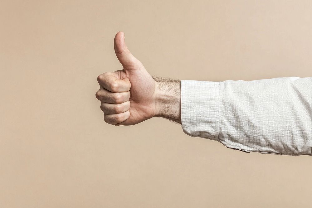 A hand of white man with his thumb up thumbs human encouragement.