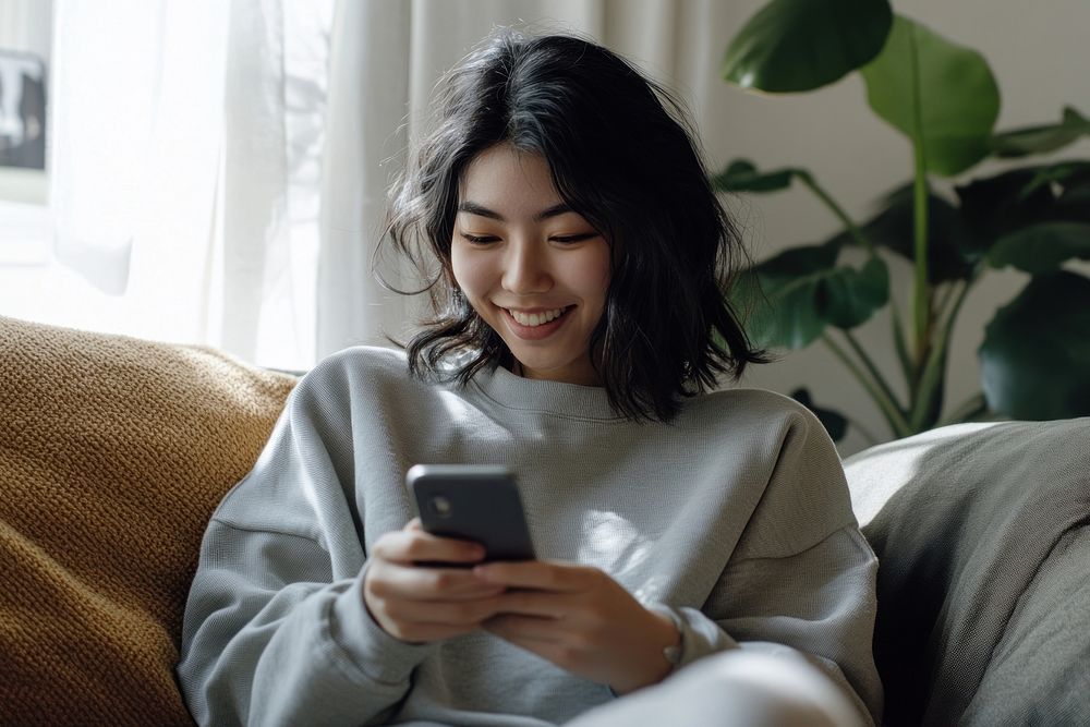 Smiling Asian woman phone mobile phone electronics.