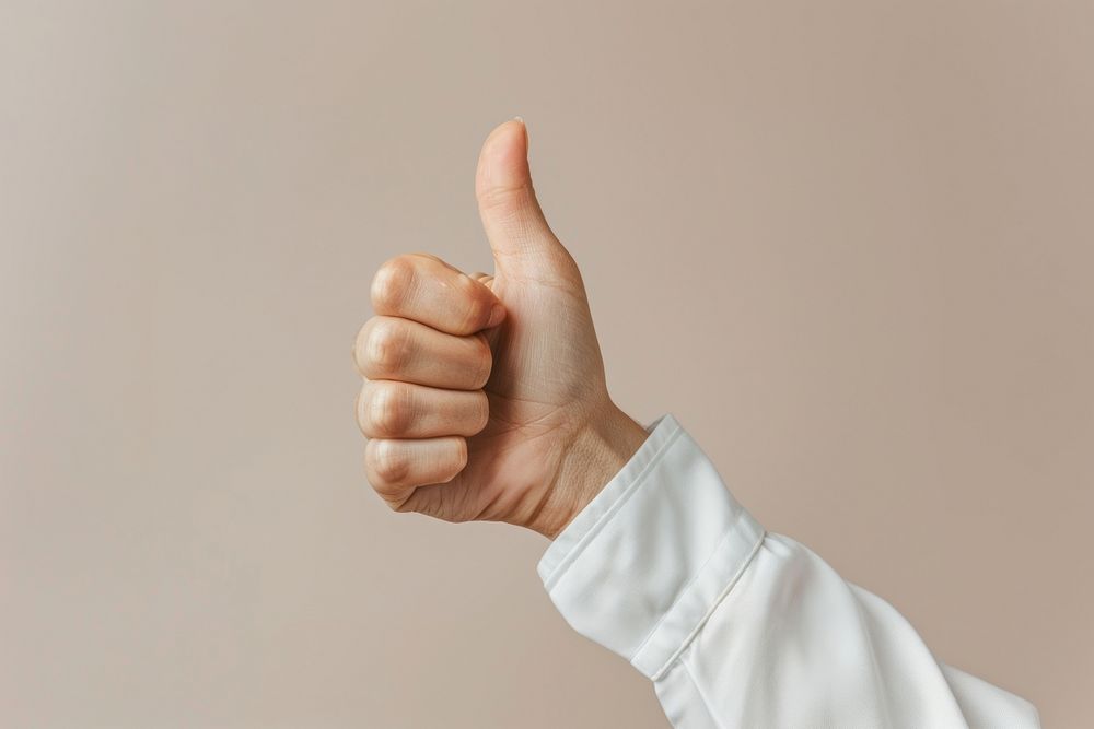 Hand showing thumbs up gesture