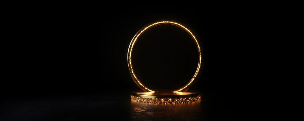 A podium illuminated with golden light against a black background glowing ring accessories.