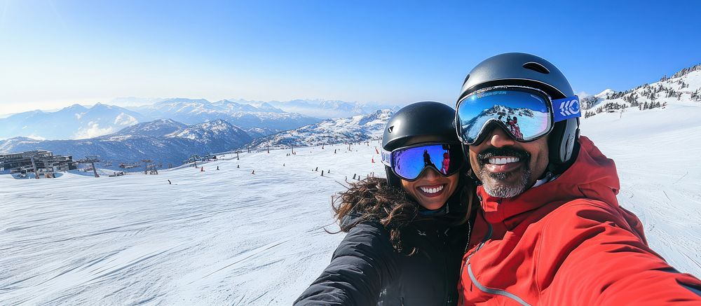 Couple wearing Ski glasses mountain helmets snow.