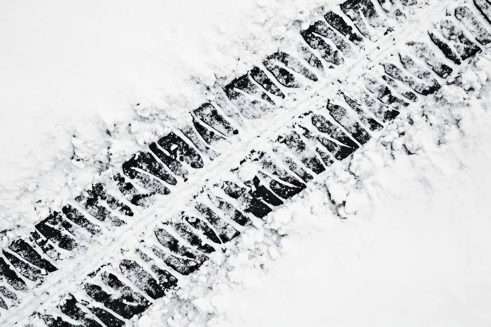 An off-road vehicle on snow texture nature tracks.