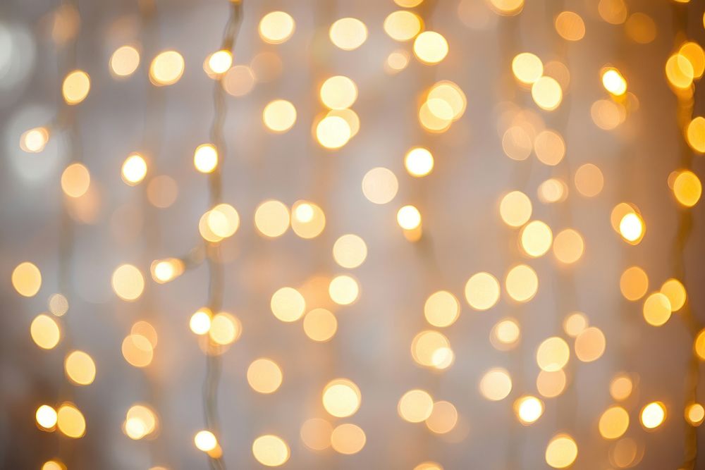 Golden lights with a bokeh effect celebration background abstract.