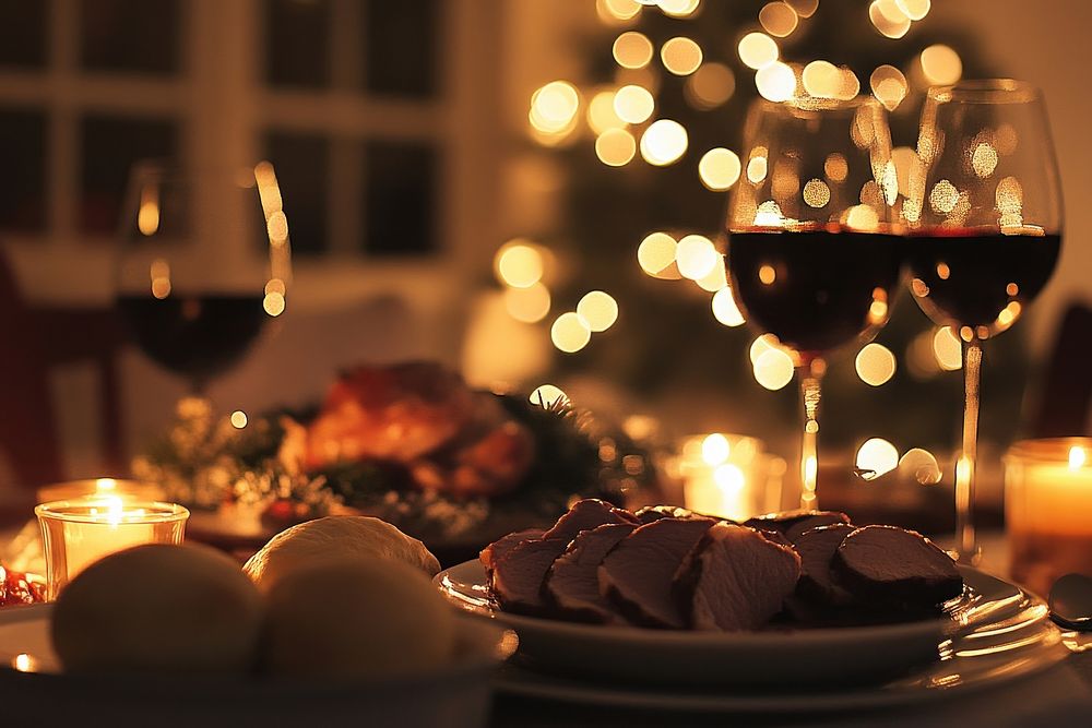 Christmas dinner with dishes and meat on the table wine christmas glasses.