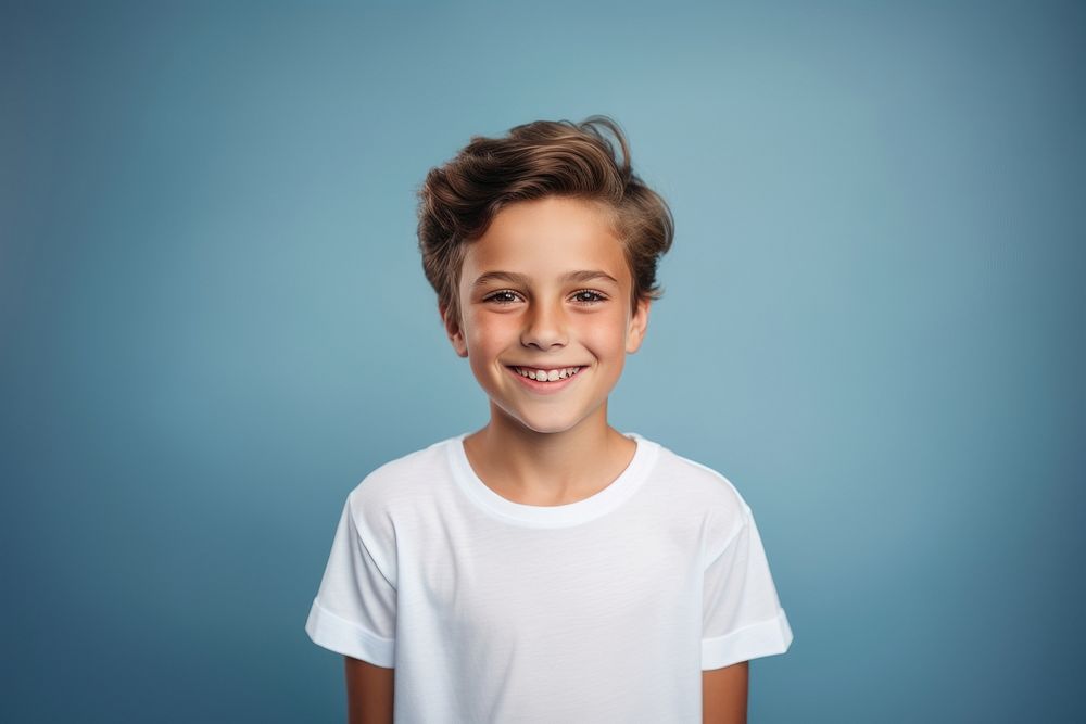 A young boy wearing a white T-shirt photo background portrait.