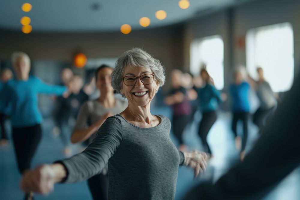 A smiling senior woman dancing at the gym seniors active happy.