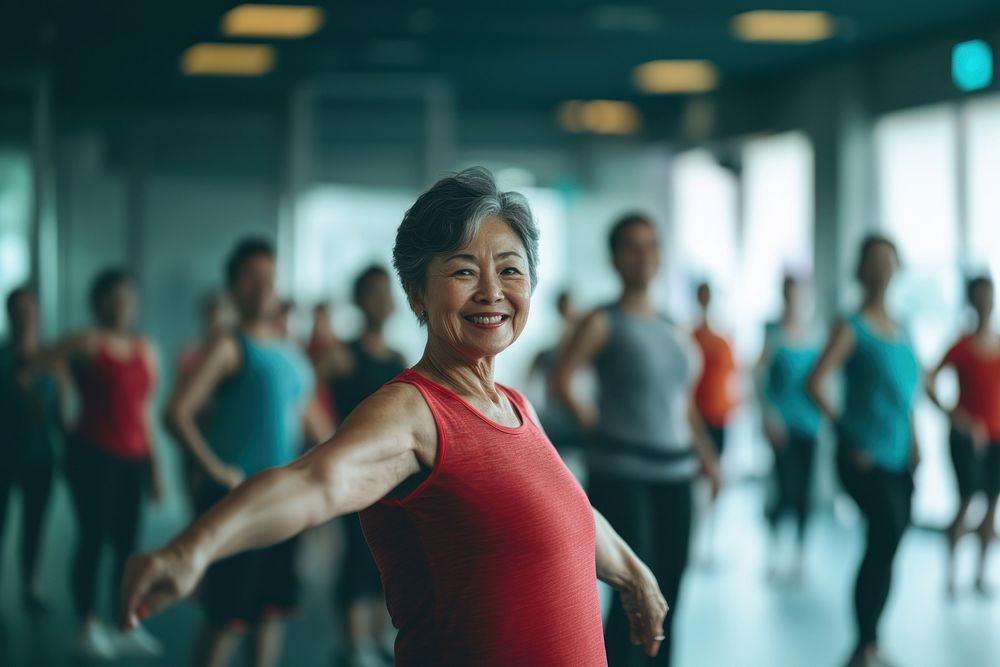 A smiling senior asian woman dancing at the gym lifestyle active adult.