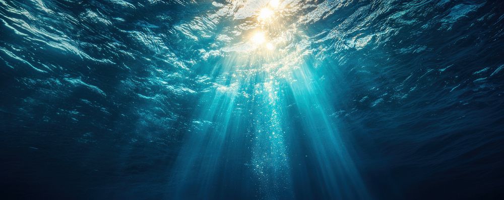 Underwater background with sun rays shining through the water surface underwater sunlight nature.