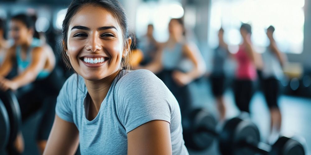 Woman doing a workout in a gym smiling person happy.