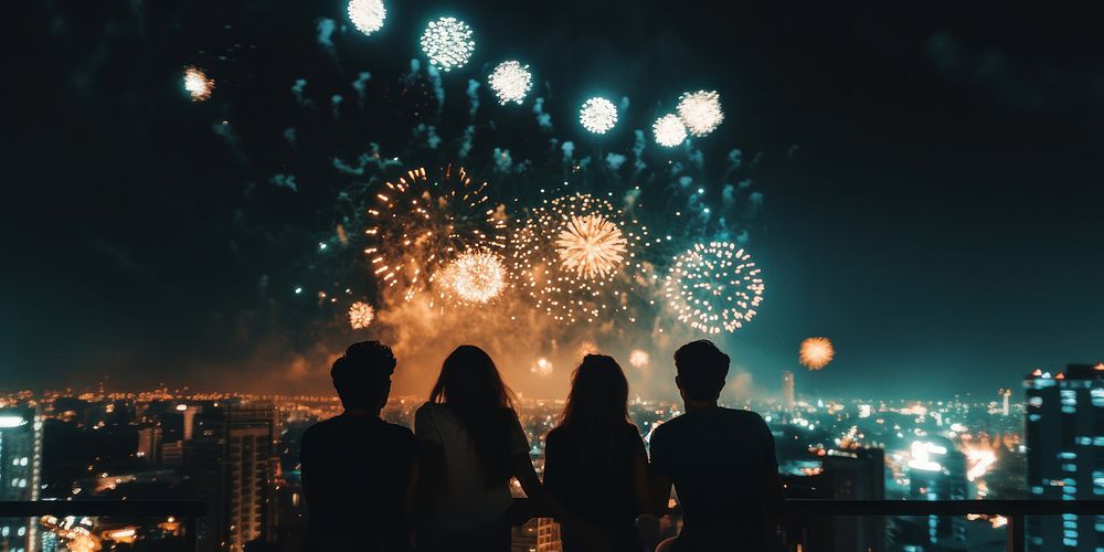 Real friends celebrate fireworks rooftop person.