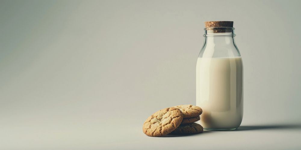 Bottle on the table milk background cookies.