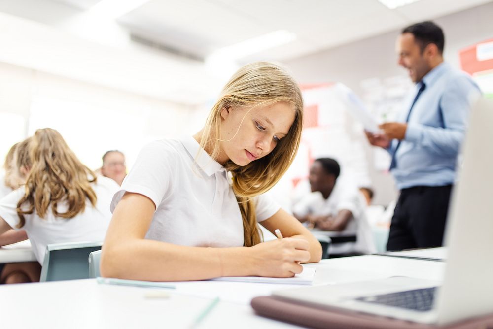 Teenage girl study in classroom. Teenage student girl learning from laptop at school with teacher teaching. Students in…