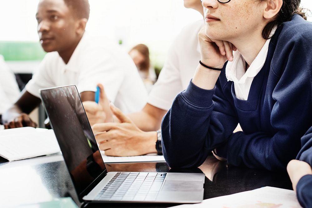 Diverse students in classroom, focused on learning. Young male and female students, African American, engaged in education.…