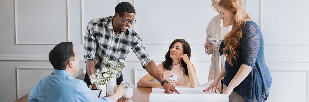 Diverse group of men and women collaborating on a project. Group of people discussing ideas. Teamwork and collaboration…