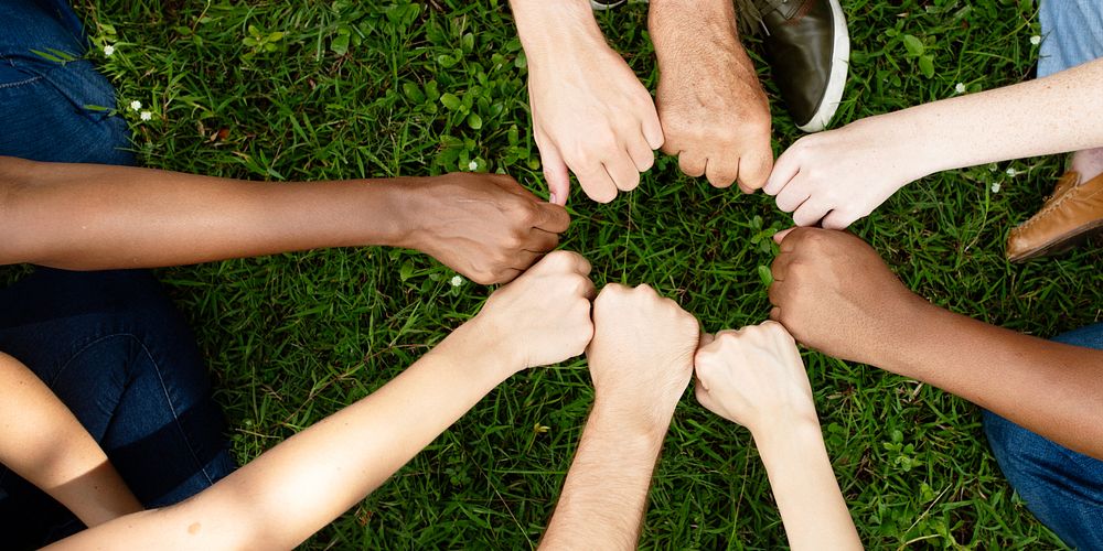 Diverse community with hands in a circle. Nature and environment. Diverse group of people hands together in unity. Group of…