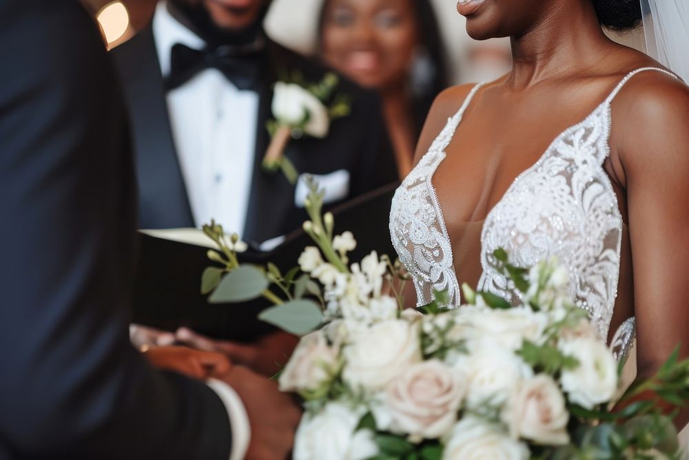 Black couple exchanging their vows wedding dress tuxedo.