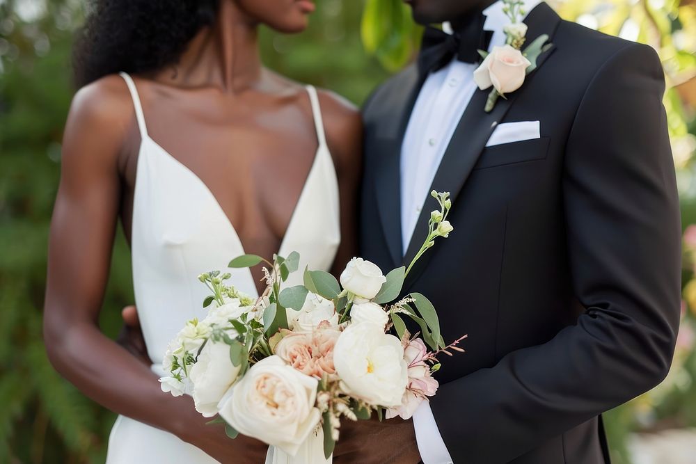 Black couple exchanging their vows wedding tuxedo dress.