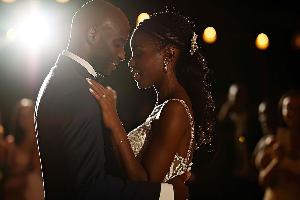 Black couple having their first dance at their wedding portrait lighting jewelry.