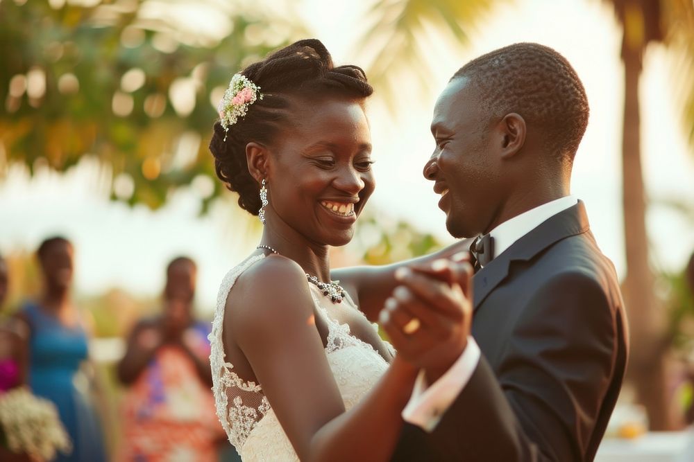 African couple dancing at their wedding ceremony outdoors jewelry.