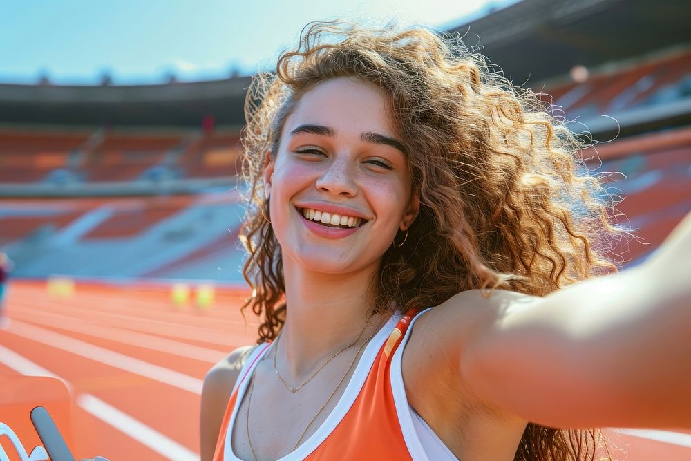 A athlete girl take a selfie at sport stadium sports smile competition.