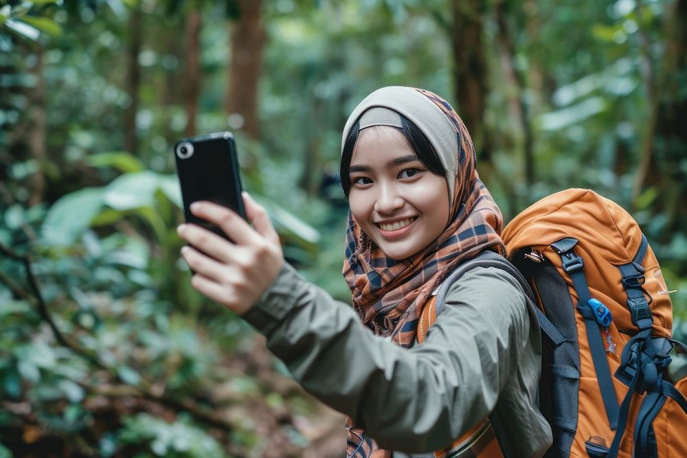Backpacker Malaysian girl take a selfie travel nature photographing.