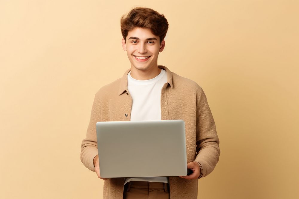 American teenager student holding laptop using computer technology presenting elearning portrait smiling happy. AI generated…
