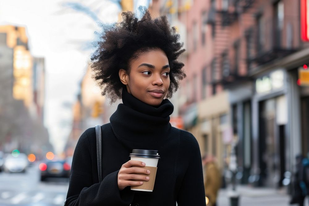 An african american woman walking with a coffee on a city sidewalk cup mug architecture.