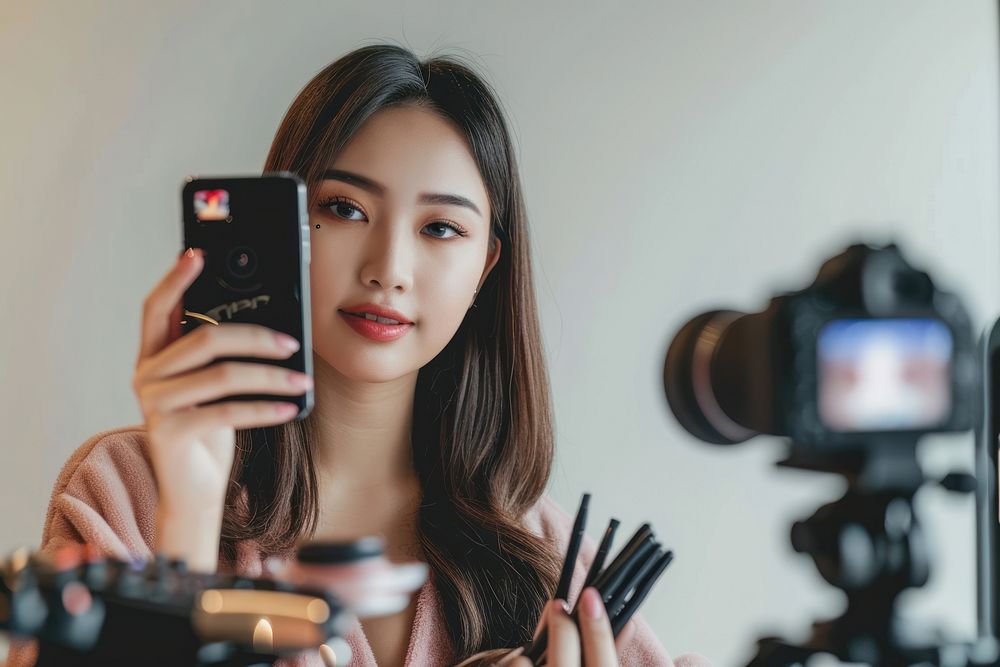 An asian girl take a selfie with video recording in front photo photographing photographer.