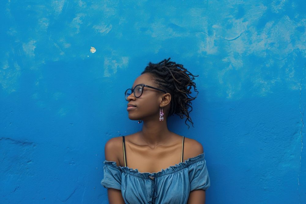 African american woman adult blue wall.