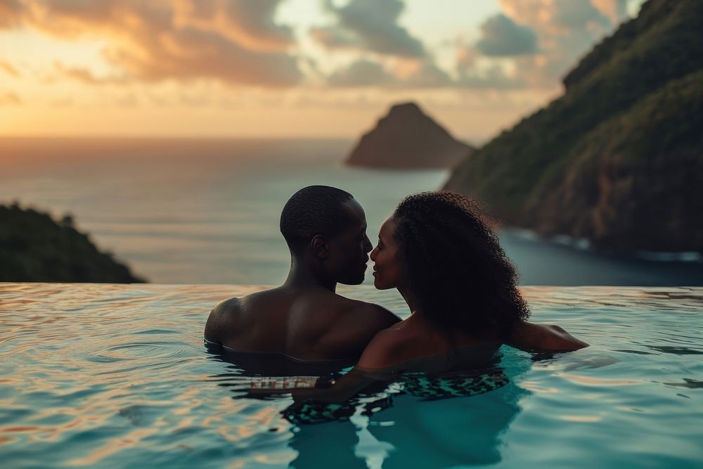 Black couple on their honeymoon swimming outdoors romantic.