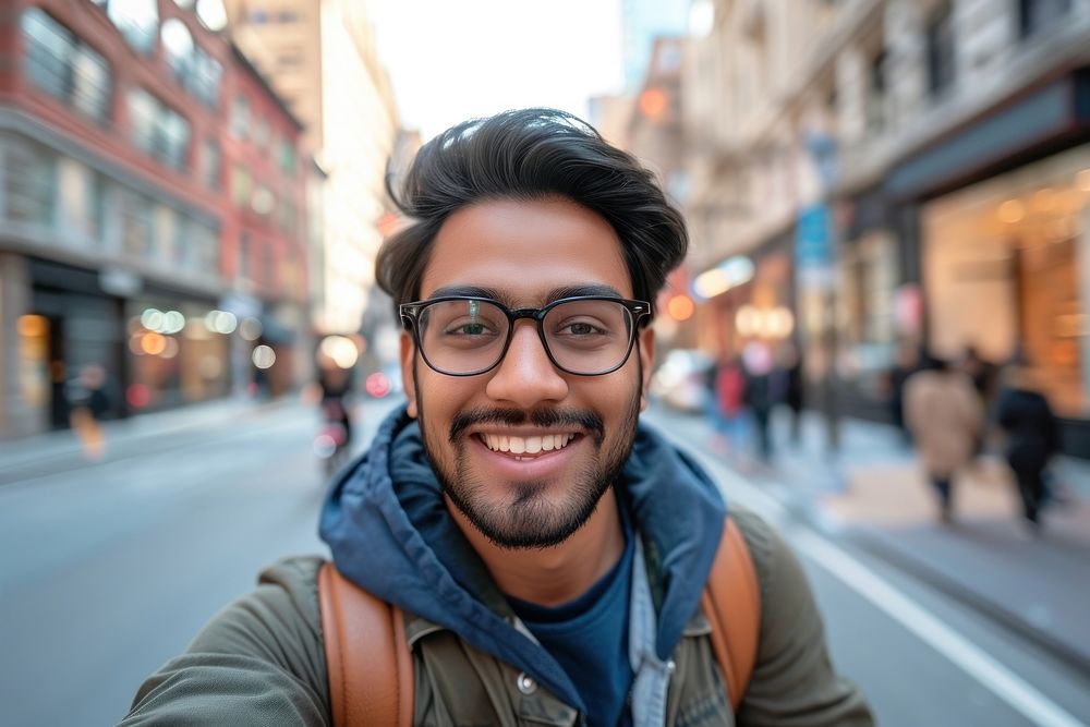 Indian american man city portrait glasses.