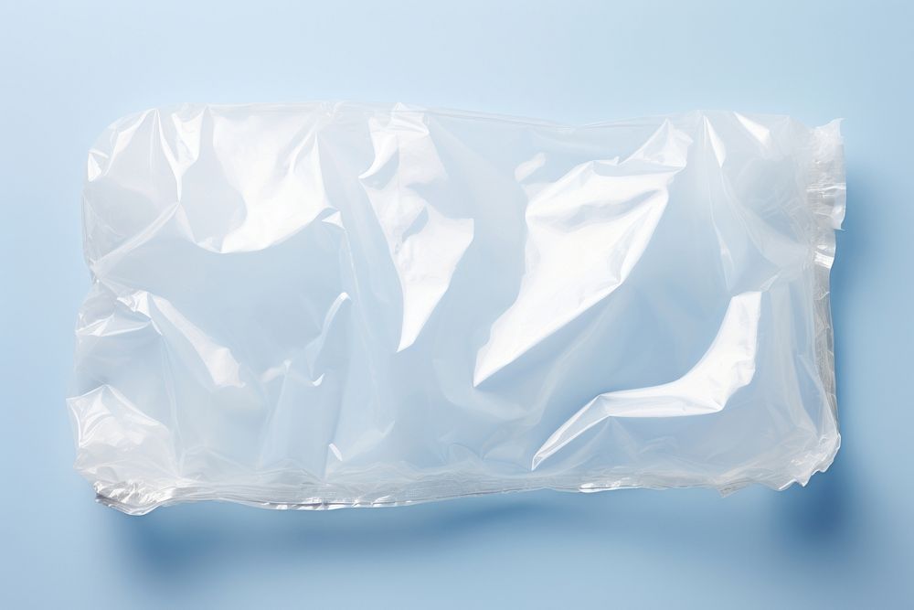 Plastic wrapping over a cloud white crumpled diaper.